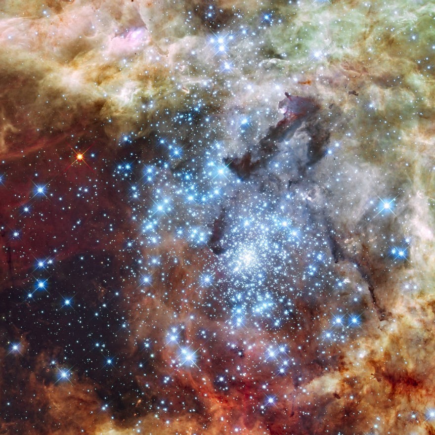 Hubble Watches Star Clusters on a Collision Course. Astronomers using data from NASA's Hubble Space Telescope caught two clusters full of massive stars that may be in the early stages of merging. The 30 Doradus Nebula is 170,000 light-years from Earth. What at first was thought to be only one cluster in the core of the massive star-forming region 30 Doradus has been found to be a composite of two clusters that differ in age by about one million years. The entire 30 Doradus complex has been an active star-forming region for 25 million years, and it is currently unknown how much longer this region can continue creating new stars. Smaller systems that merge into larger ones could help to explain the origin of some of the largest known star clusters. The Hubble observations, made with the Wide Field Camera 3, were taken Oct. 20-27, 2009. The blue color is light from the hottest, most massive stars; the green from the glow of oxygen; and the red from fluorescing hydrogen. Image Credit: NASA, ESA, and E. Sabbi (ESA/STScI).